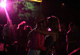 These festivalgoers smooched in the moonlight (and florescent light) of Glastonbury festival.
