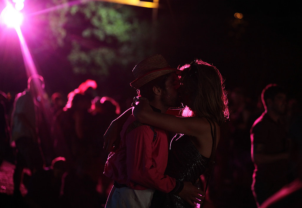 These festivalgoers smooched in the moonlight (and florescent light) of Glastonbury festival.
