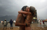 This pair smooched in the rain at the Chiemsee Reggae Summer music festival in Uebersee, southern Germany. 
