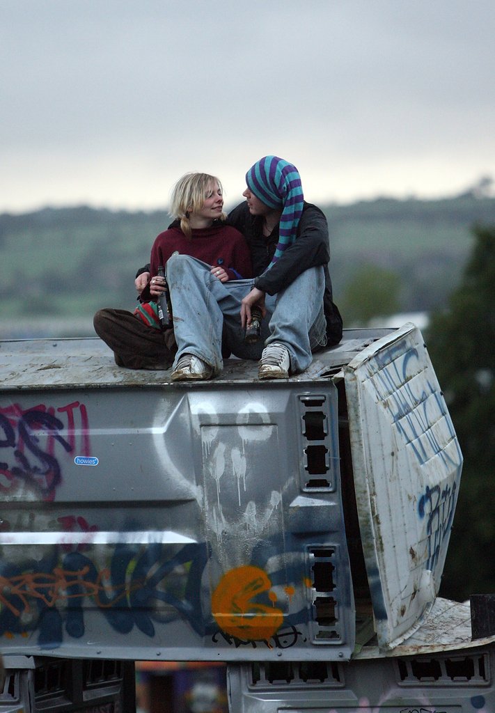 This couple chatted together on top of the Banksy installation during Glastonbury in Somerset, England.
