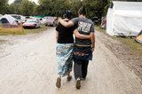 A couple walked together at Christian music festival Cornerstone Festival in Bushnell, IL.
