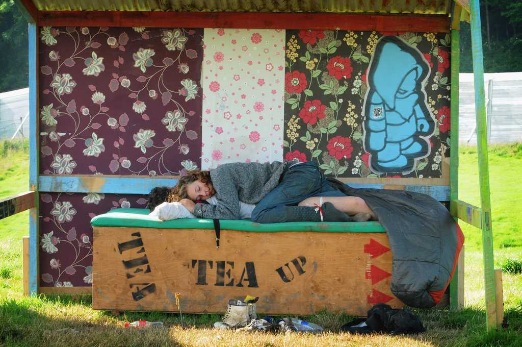 Glastonbury Music Festival goers napped together.
