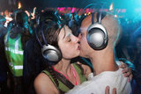 A couple in headphones smooched at the Glastonbury Music Festival in England.
