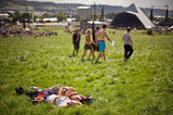 A couple soaked up the sun in the grass at the annual Glastonbury festival in England.
