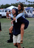 A guy gave his lady friend a ride at Coachella in Indio, CA.
