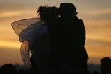 This couple got close to watch the sunrise at the Glastonbury Festival in England.
