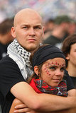 Fans embraced during a performance at the International Woodstock Festival in Kostrzyn, Poland. 
