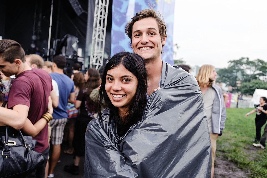 A pair of concertgoers cozied up in a blanket at the Catalpa Festival at Randall's Island in New York City.  
