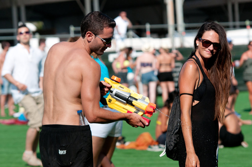 A guy goofed off with his lady friend at Ibiza 123 Festival: Rocktronic Sunset Strip in Ibiza, Spain. 
