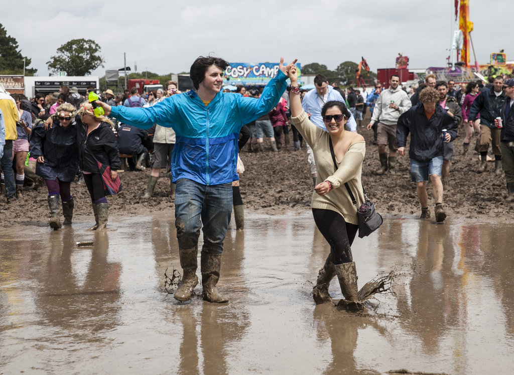 A pair walked through the mud at the Isle of Wight Festival 2012 at Seaclose Park.
