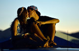 A couple kissed on top of a car ahead of the Coachella Music Festival in Indio, CA.
