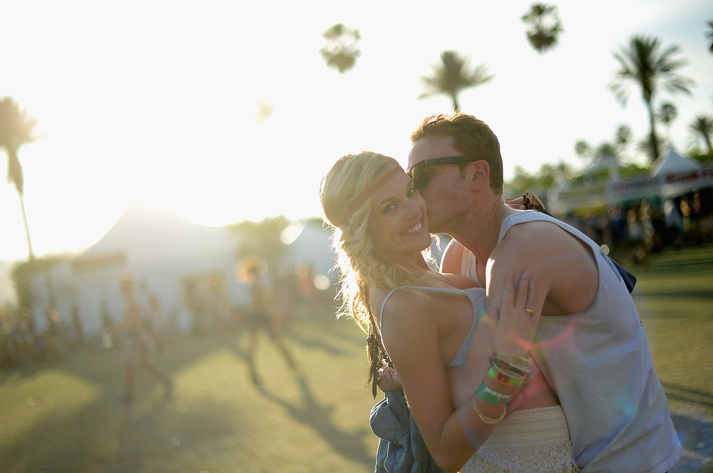 A guy kissed his lady at Coachella in Indio, CA.
