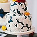 Don't the floral embellishments of this darling cake remind you of doilies? Not your grandma's doilies, though — set against a deep blue base, these are ultrachic. 
Photo by Pen/Carlson via Style Me Pretty
